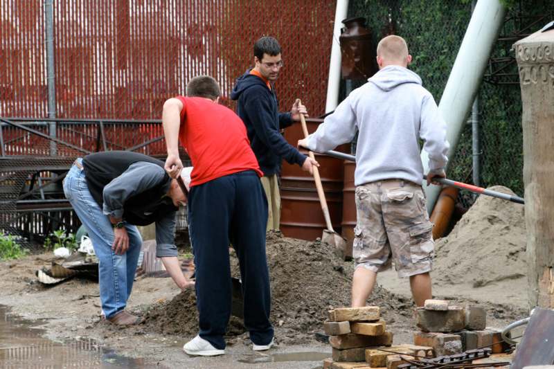 a group of men digging in dirt