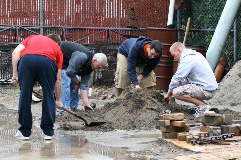 a group of men digging in the dirt