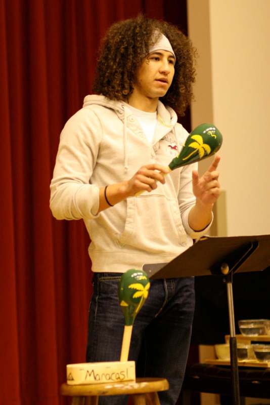 a man playing maracas on a stand