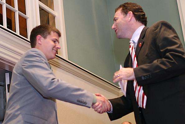 a man shaking hands with another man
