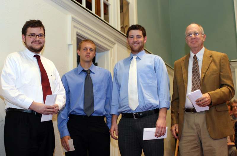 a group of men standing in a hallway
