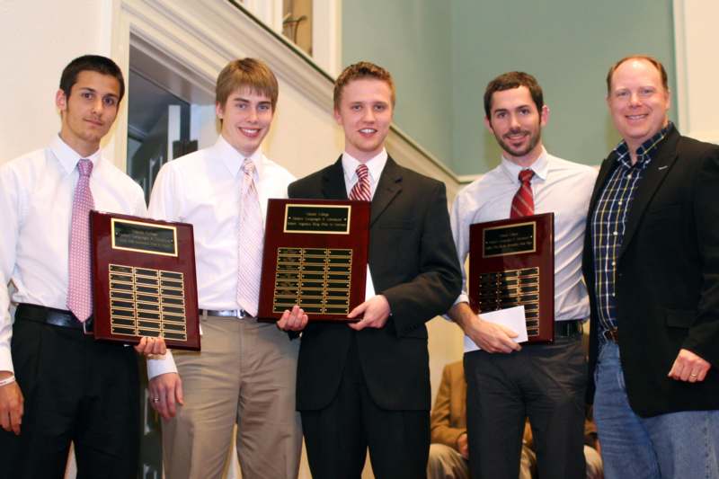 a group of men holding plaques