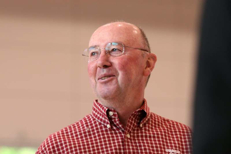 a man wearing glasses and a red and white checkered shirt