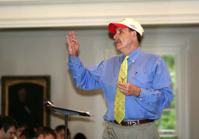 a man in a blue shirt and red hat