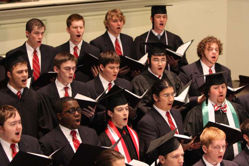 a group of people singing in a choir