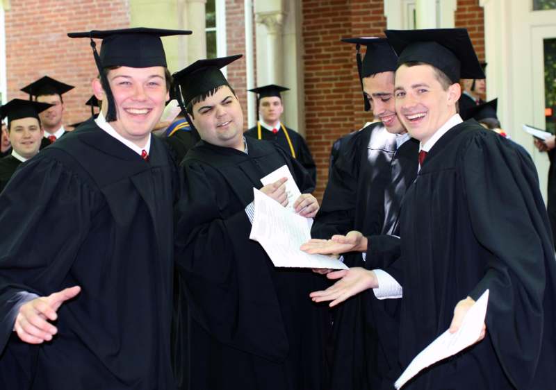 a group of young men in graduation gowns