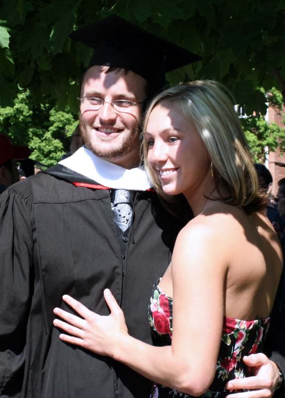 a man and woman in graduation gowns