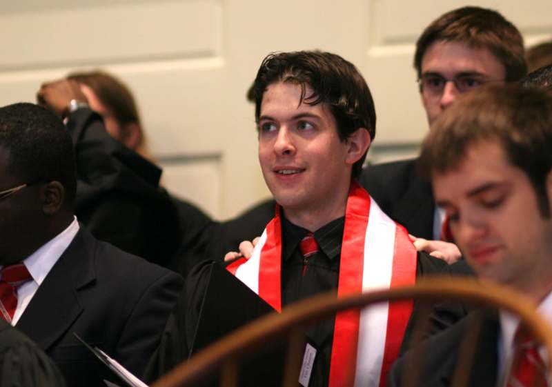 a man wearing a red and white scarf