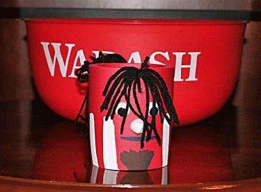 a red bucket with a cartoon face
