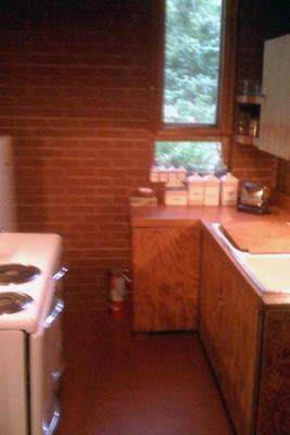 a kitchen with a brick wall