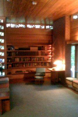a room with a desk and bookshelf