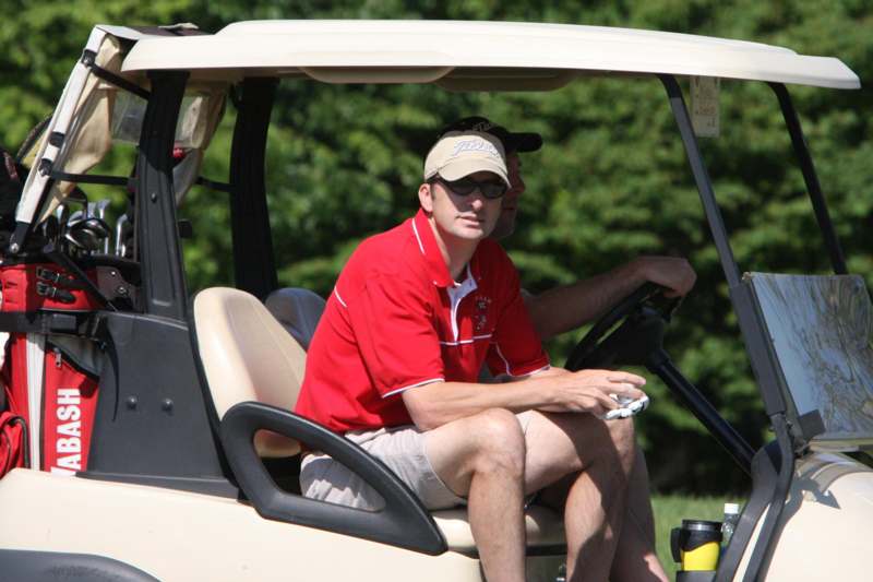 a man in a golf cart
