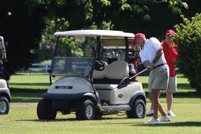 a man playing golf on a golf cart