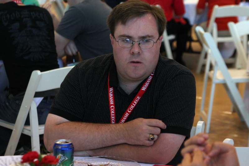 a man sitting at a table with his arms crossed