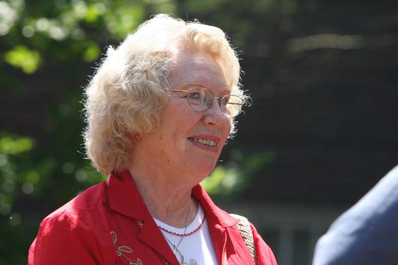 a woman wearing glasses and a red jacket