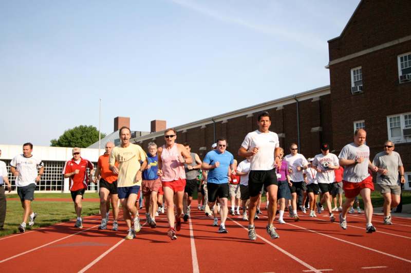a group of people running on a track