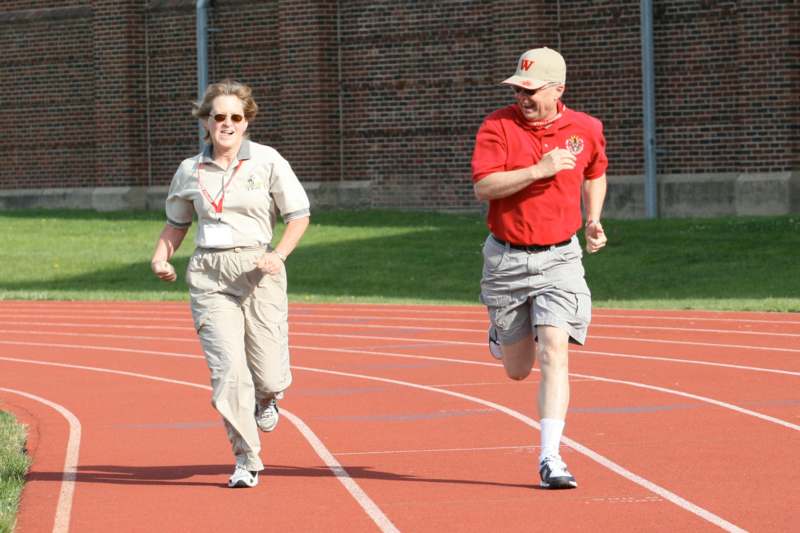a man and woman running on a track