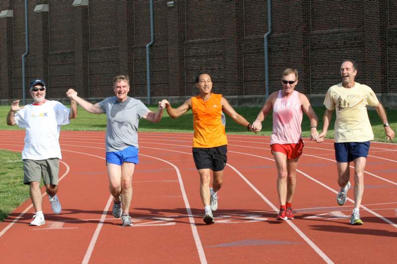 a group of people holding hands on a track