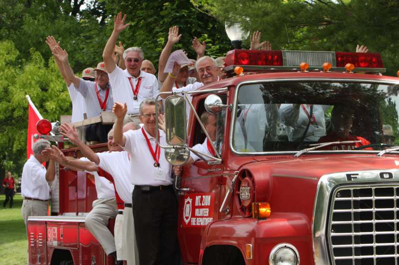 a group of people standing in front of a fire truck