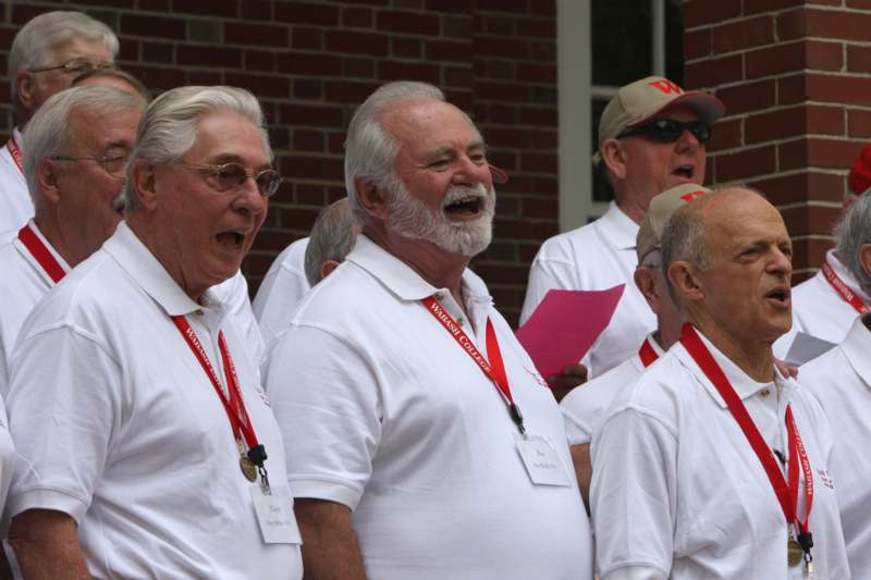 a group of men wearing white shirts