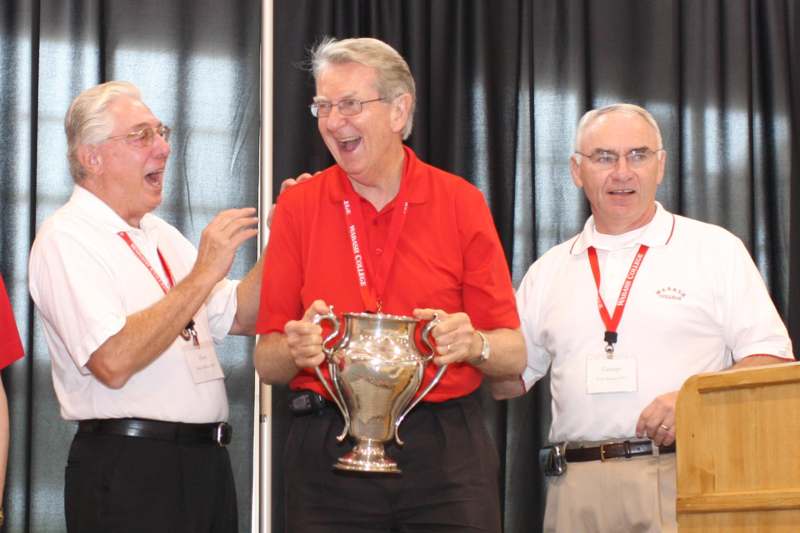 a group of men holding a trophy