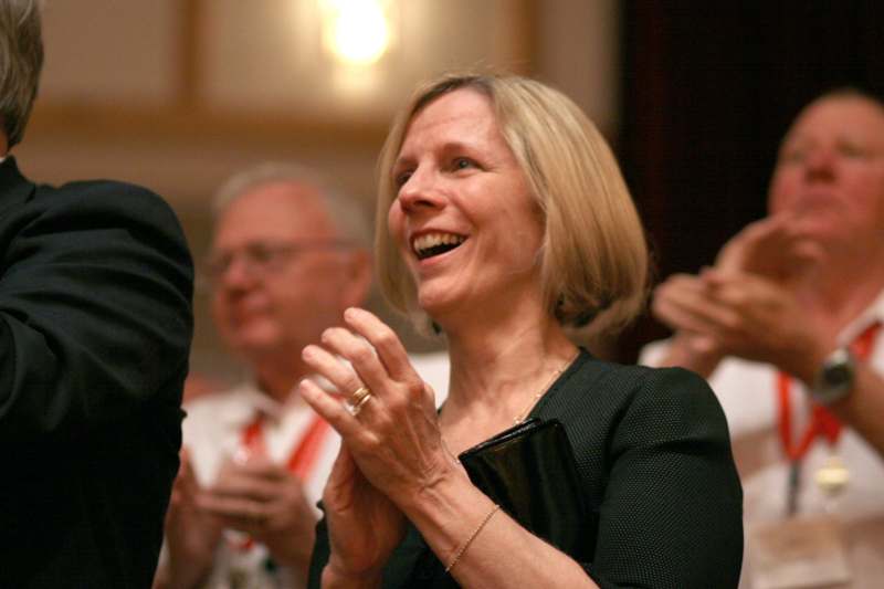 a woman laughing and clapping her hands