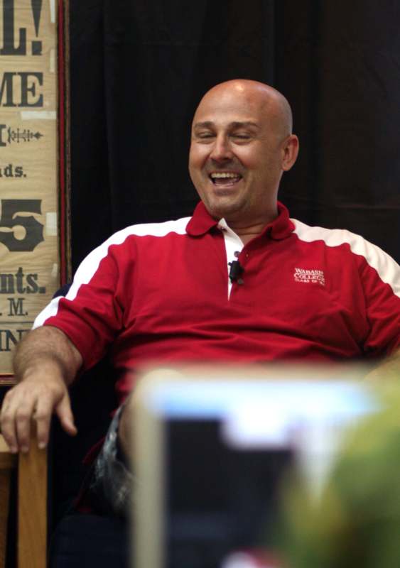 a man laughing in a chair