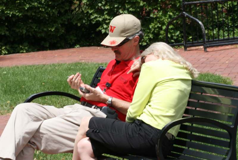 a man and woman sitting on a bench
