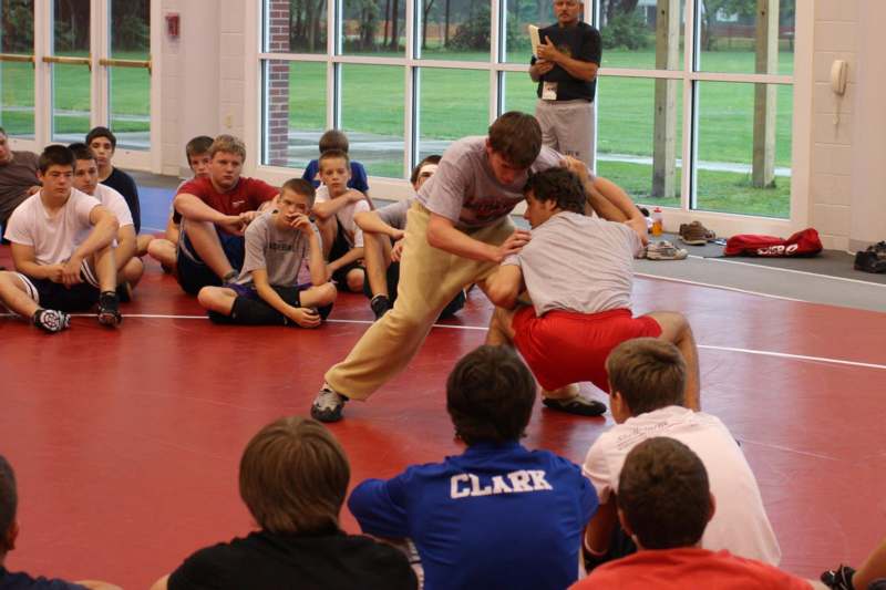a group of kids wrestling in a gym