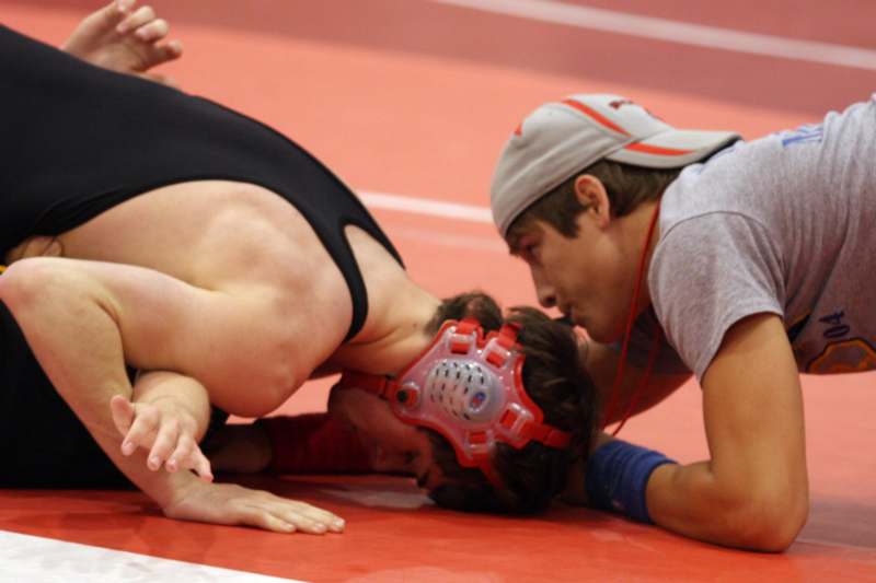a man wrestling on the ground