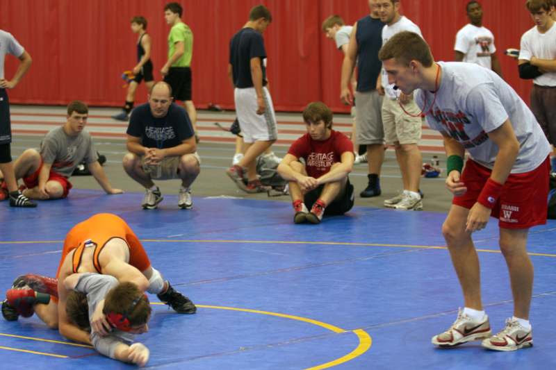a group of people on a wrestling mat