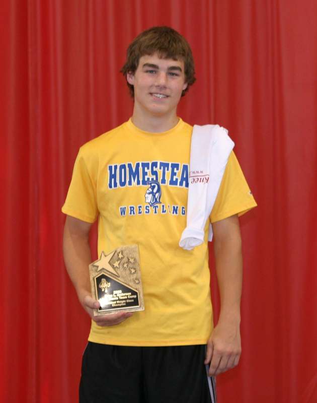 a young man holding a trophy