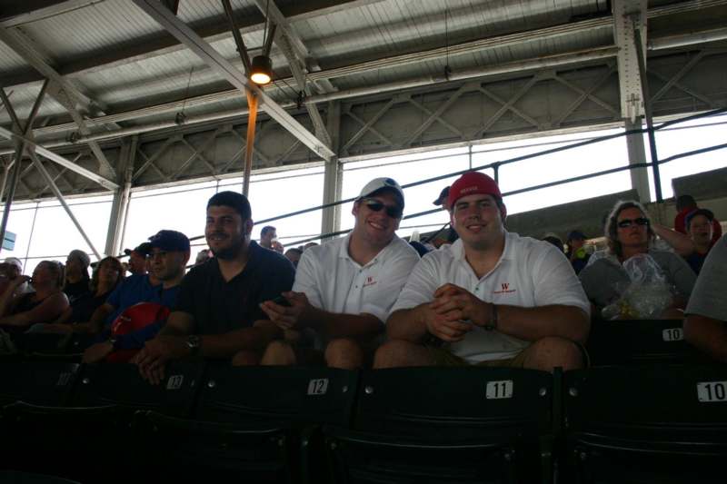 a group of men sitting in a stadium
