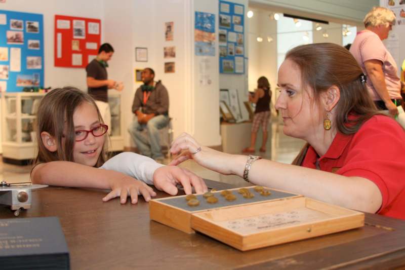 a woman and a girl playing a board game