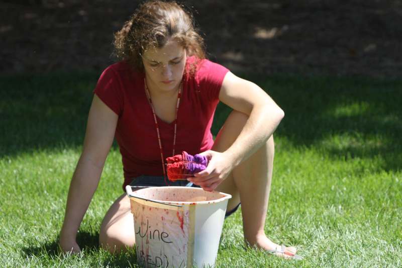 a woman painting a bucket of wine