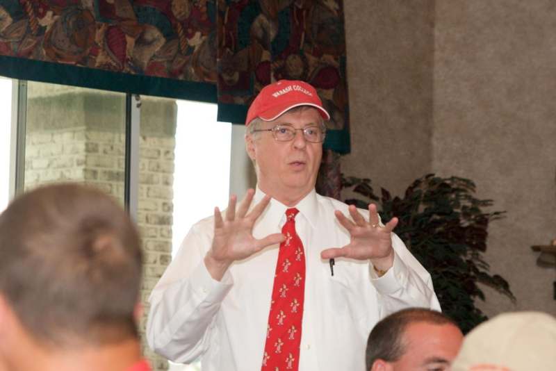 a man wearing a red hat and tie