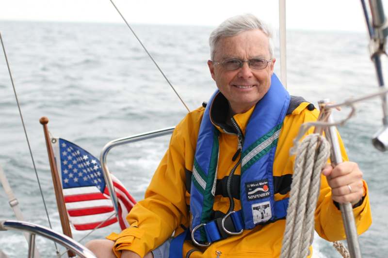 a man in a yellow jacket on a boat