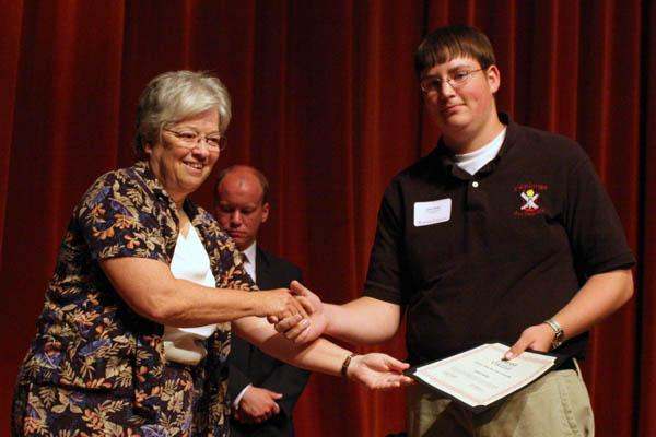 a man shaking hands with a woman