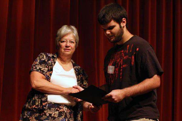 a man and woman holding a piece of paper