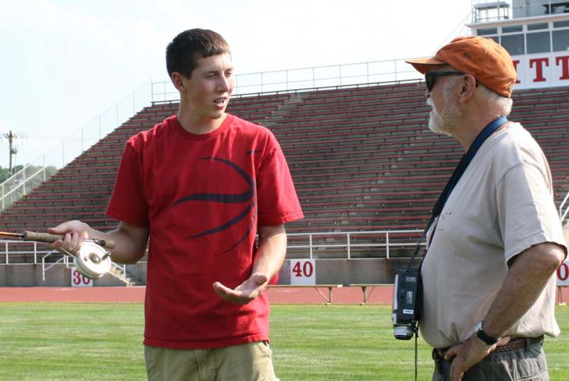 a man talking to a man on a field
