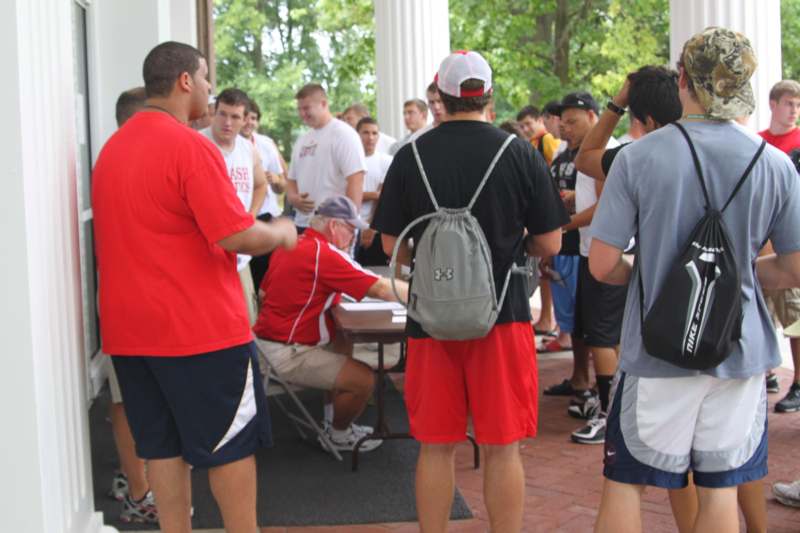 a group of people standing around a table