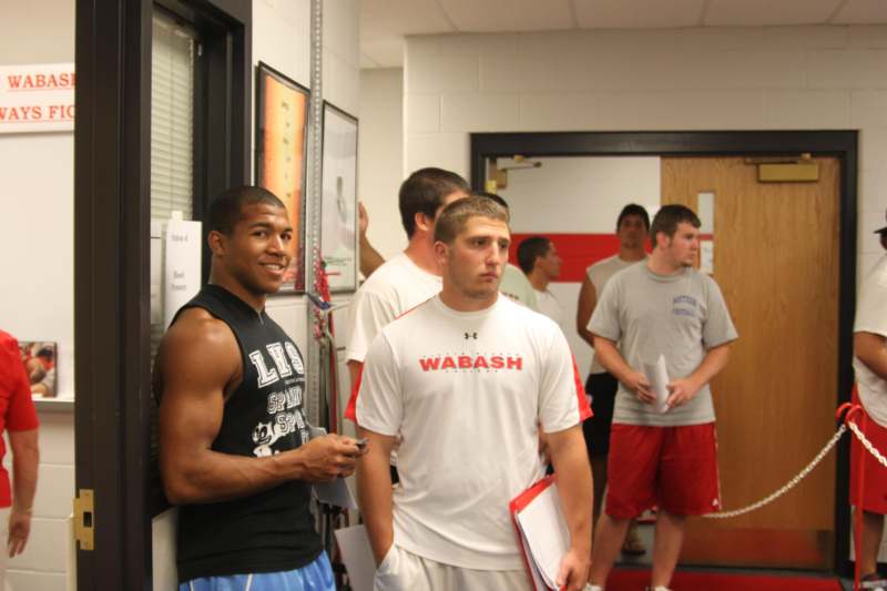 a group of men standing in a hallway