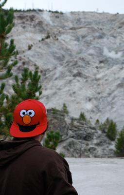 a person wearing a red hat with a cartoon character on it