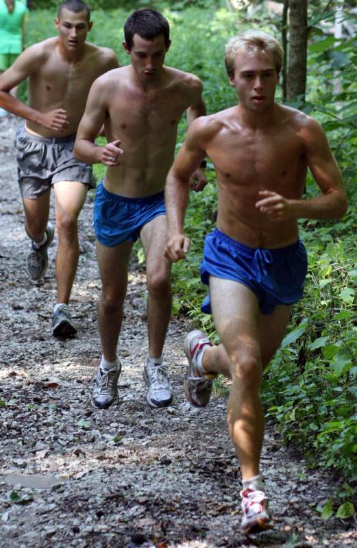 a group of men running on a trail