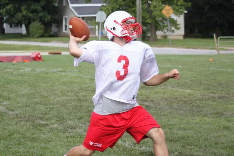 a man in a football uniform holding a football