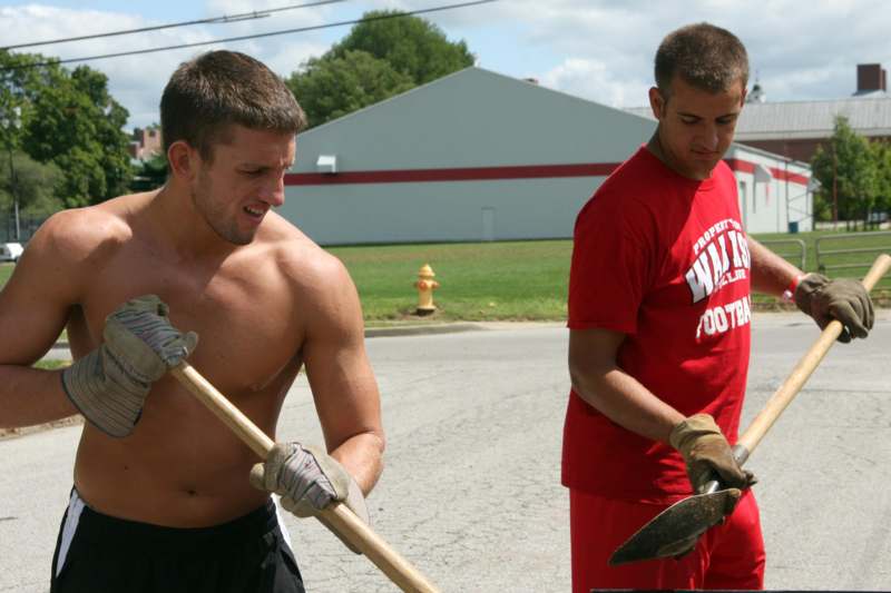 a couple of men holding shovels
