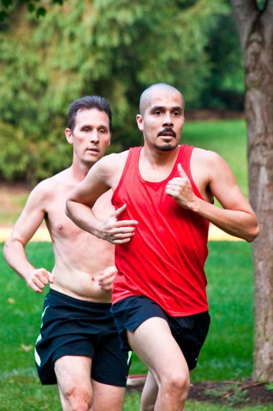 two men running in a park