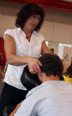 a woman massaging a man's head