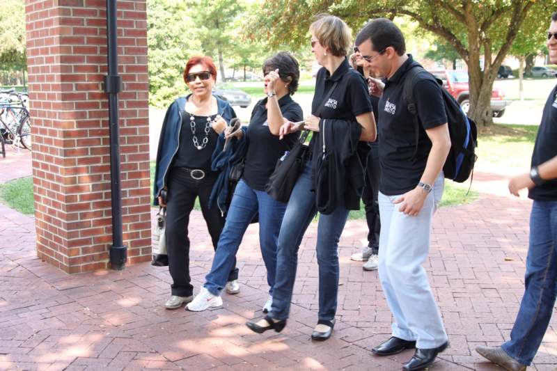 a group of people standing on a brick sidewalk