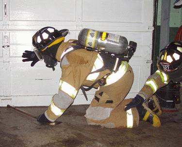 a firefighter kneeling on the ground